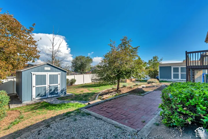 Expansive yard featuring a brick paver patio, established trees, garden boxes, and custom built storage sheds measuring 10'x16' and 7'x18'.