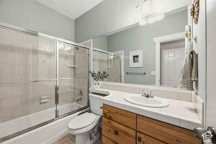 Bathtub with sliding glass enclosure and tiled surround