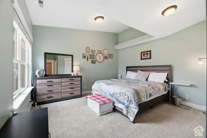 Recessed ceiling beams, ceiling-mounted lighting, light-toned wall color, and carpeted flooring