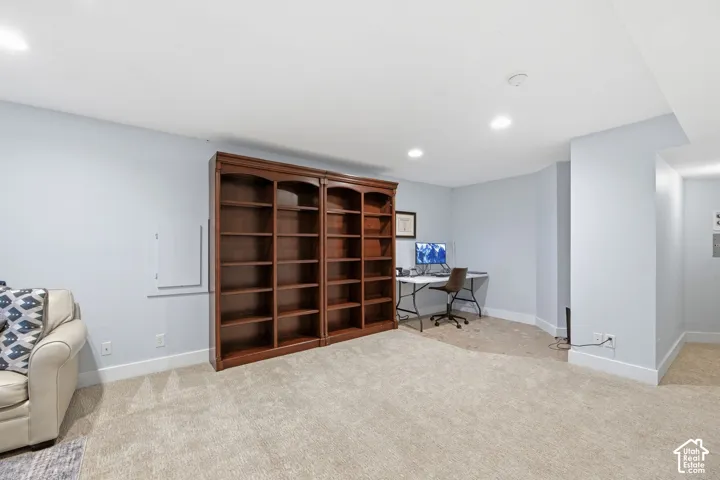 Built-in wood-finish bookcases, recessed lighting, and light-toned carpeting