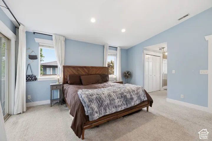 Plush carpeting, recessed lighting, and a sliding glass door