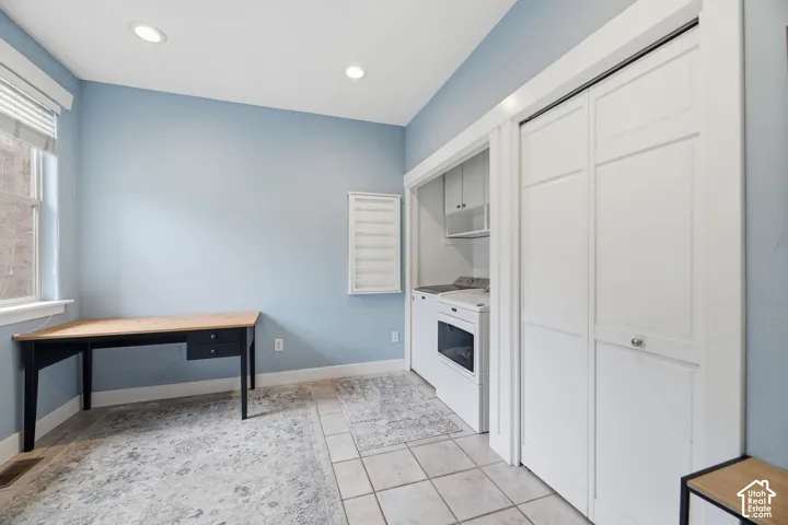 Recessed lighting illuminates the space with a window offering natural light