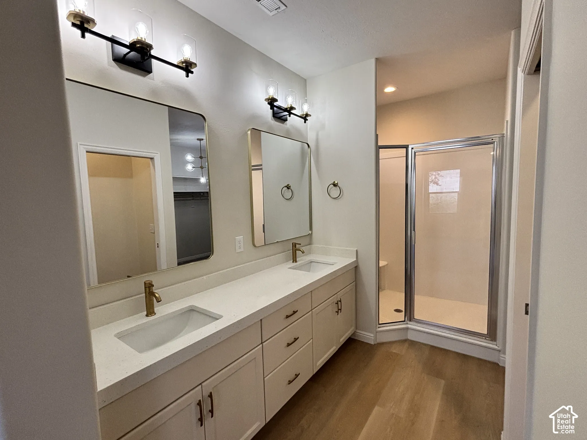 Dual vanity with undermount sinks, gold-finish fixtures, and integrated countertop
