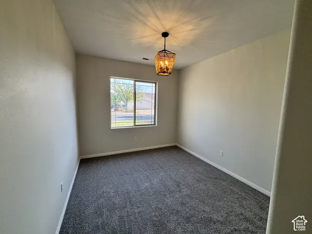 Recessed window with white trim, dark gray carpeting, and a decorative semi-flush mount light fixture