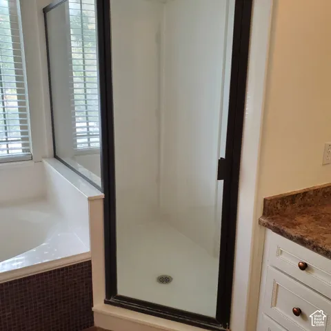 Stand-alone shower with dark-framed glass enclosure