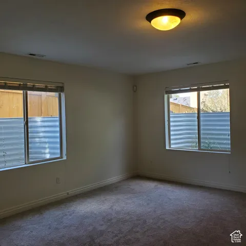 Neutral-toned walls complement the installed carpeting