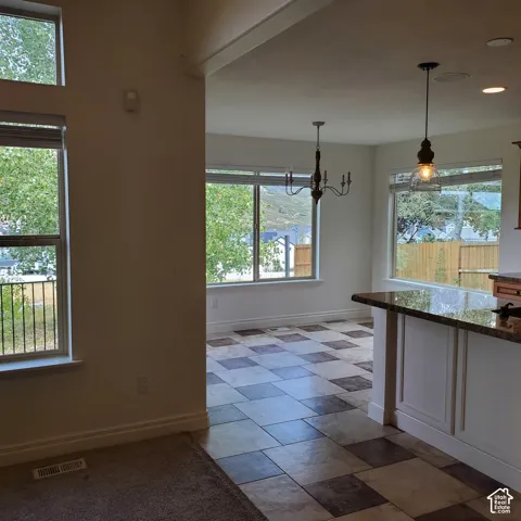 Kitchen island featuring a granite countertop and paneled base