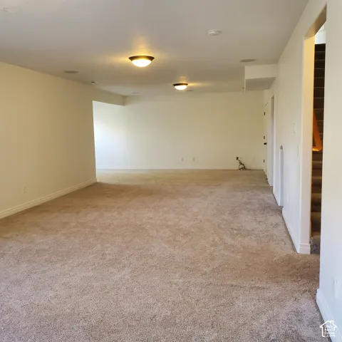 Spacious room with neutral carpeting, recessed ceiling lighting, and light-toned wall finishes
