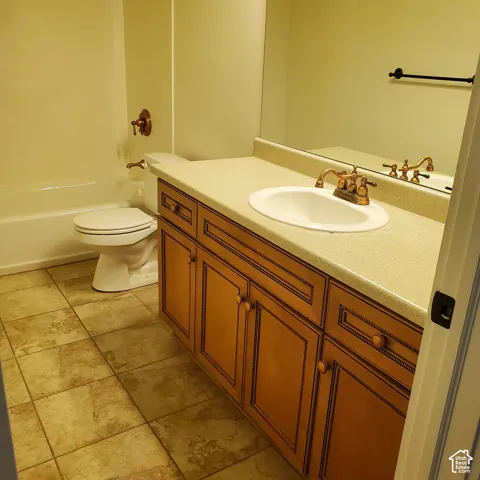 Wood-finish cabinetry with a built-in vanity, integrated sink, and bronze-finish hardware