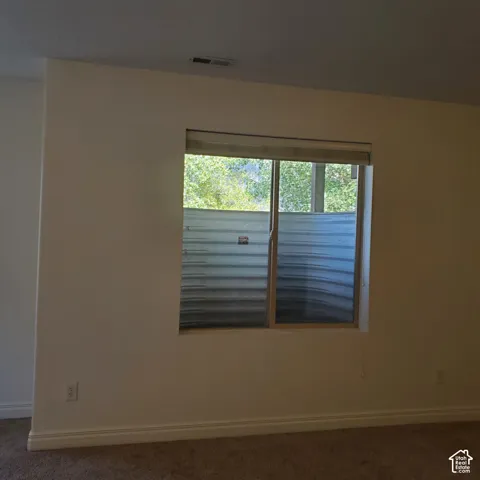 Wall-to-wall carpeting with light-toned walls and white trim