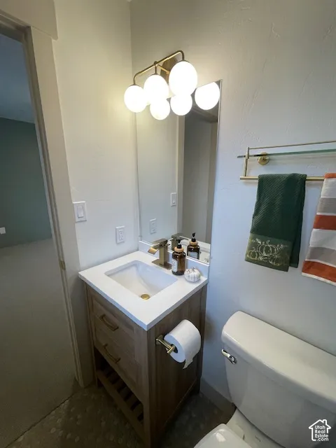 Modern vanity with integrated sink, gold-finish faucet, and coordinating wall-mounted light fixture