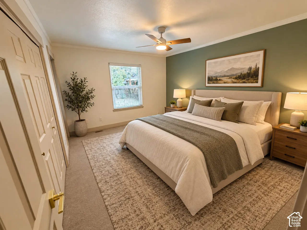 Bedroom featuring a sage green accent wall, neutral carpeting, multi-panel closet doors, a multi-blade ceiling fan with integrated lighting, and a single-pane window