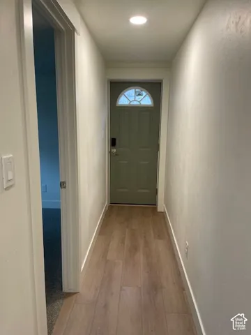 Entryway featuring wood-finish flooring, recessed lighting, and a door with an arched transom window