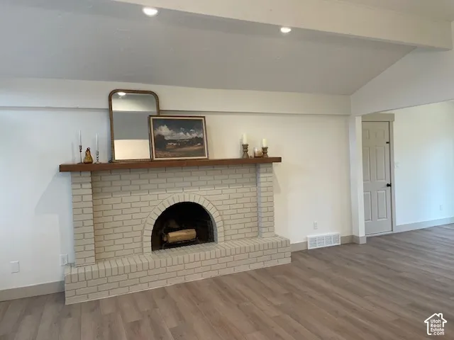 White painted brick fireplace with a wood mantel