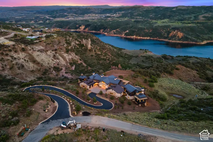 Expansive property with a curved driveway, stone fa
