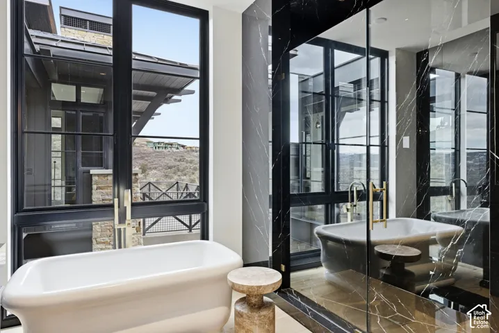 Freestanding soaking tub with floor-mounted faucet