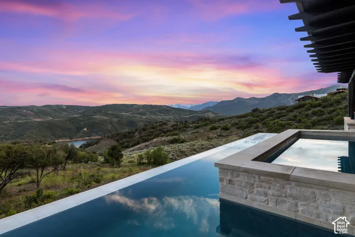 Infinity-edge pool and integrated spa with stone surround