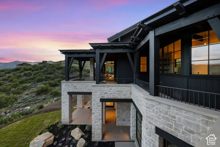 Multi-level stone exterior with dark wood accents and large pane windows