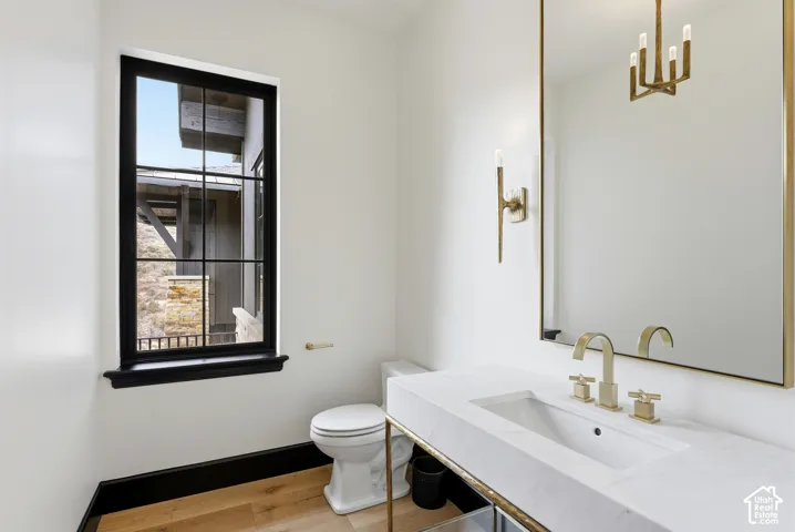 Modern vanity with an integrated rectangular sink, brass-finish faucet, and a large wall-mounted mirror