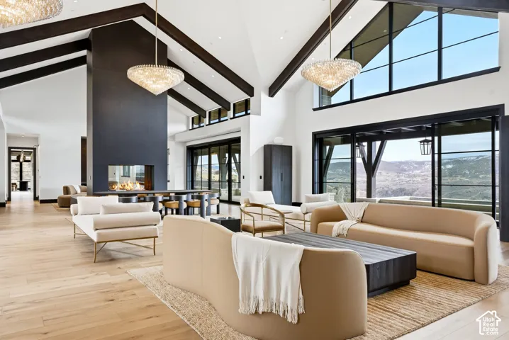 Soaring vaulted ceilings with exposed timber beams and skylights flood this open-concept living space with natural light