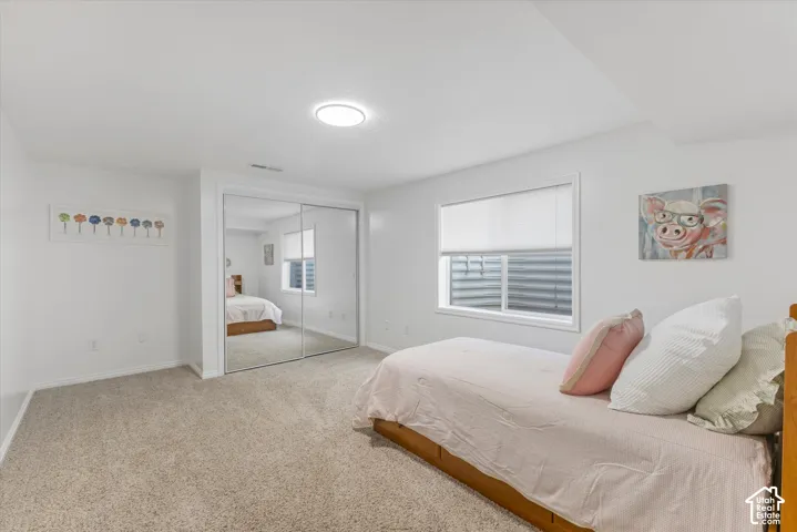 Carpeted flooring, recessed lighting, and a window with blinds