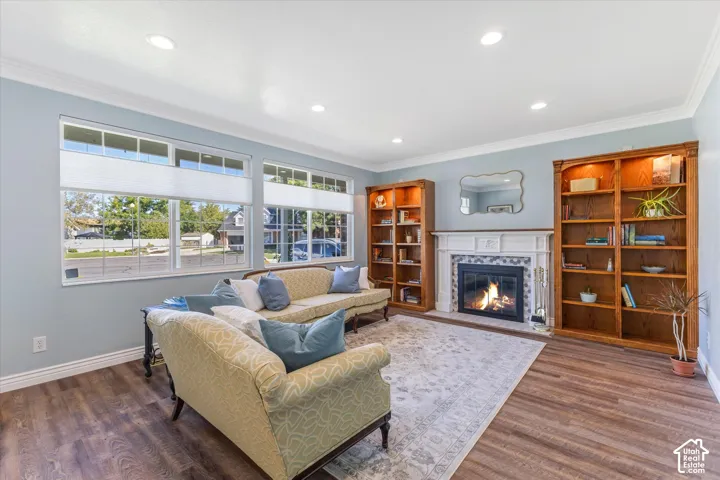Recessed lighting, wood-finish flooring, fireplace with tile surround and mantel, and built-in bookshelves