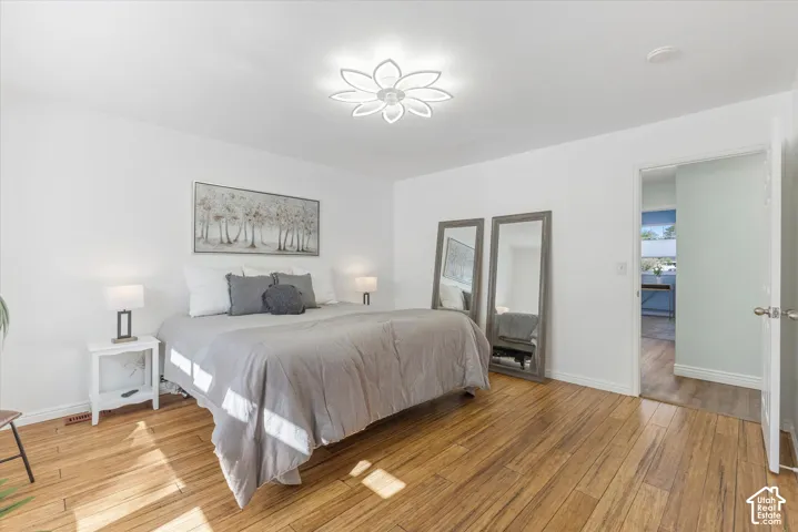 Wood-finish flooring, recessed lighting, and a modern ceiling fixture