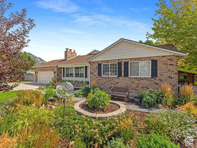 Brick exterior with white siding accents and a pitched roof