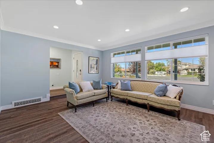 Recessed lighting, crown molding, and wood-finish flooring