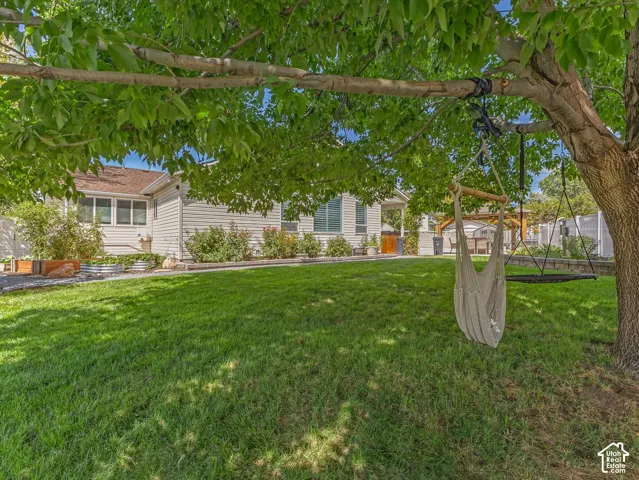 Expansive green lawn with mature trees and perimeter landscaping