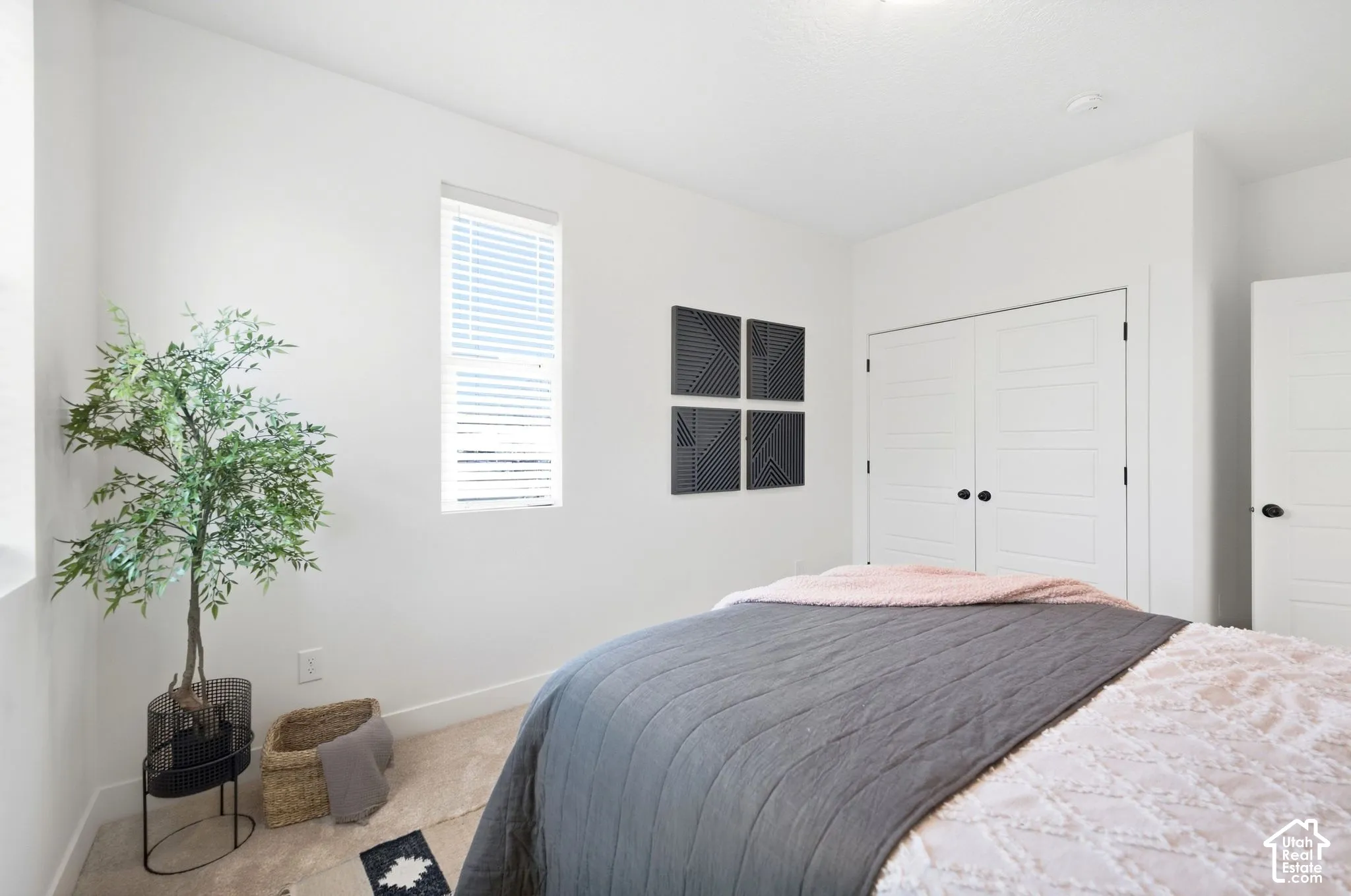 2nd bedroom. Recessed ceiling light fixture, window with blinds, paneled closet doors with black hardware, and carpet flooring