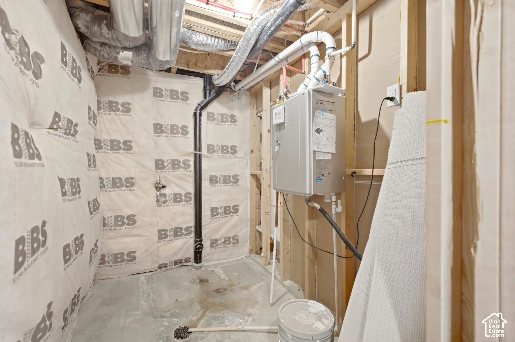 Tankless water heater, exposed ductwork, exposed framing, and insulated wall panels