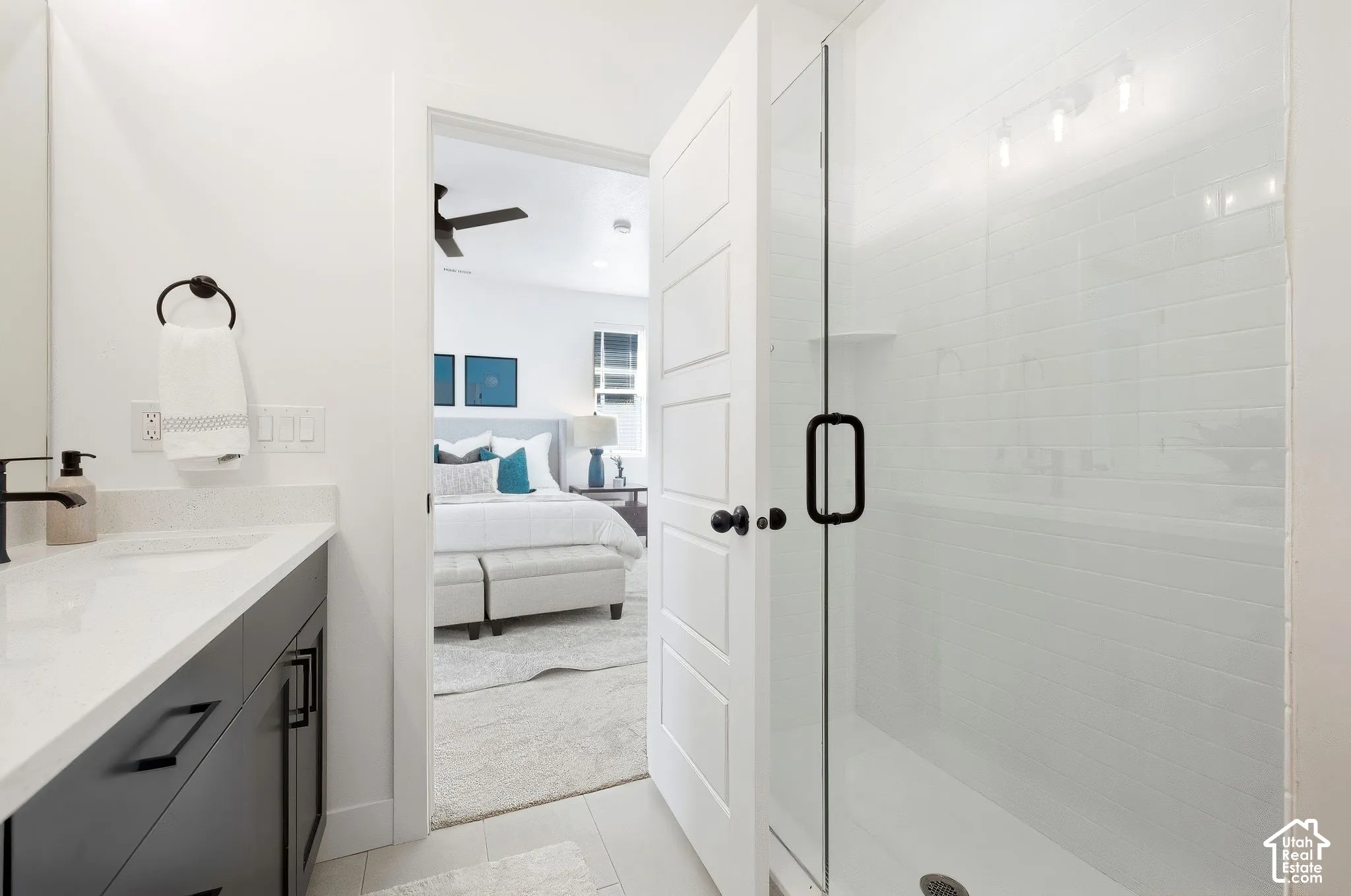 Primary bath. Glass-enclosed shower with subway tile surround