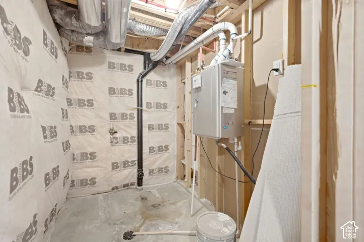 Tankless water heater, exposed ductwork, exposed framing, and insulated wall panels
