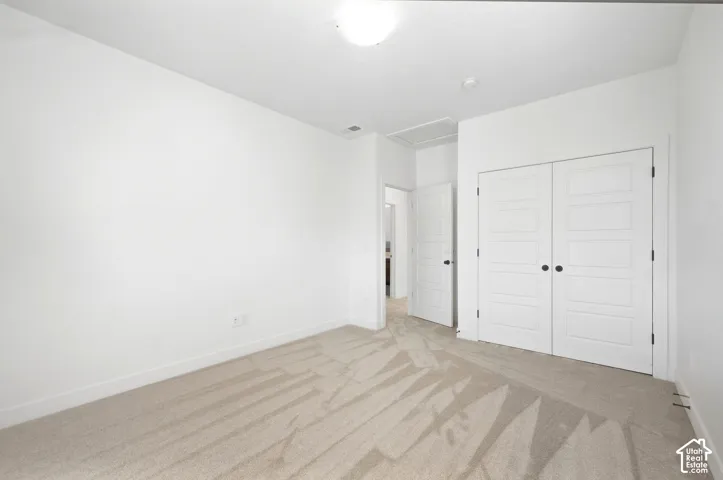 Bedroom 4 downstairs. Neutral tone wall finish with carpet flooring