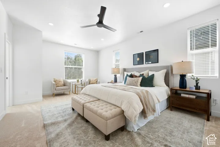 Primary bedroom. Recessed lighting, ceiling fan, and multiple windows with blinds