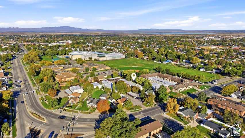 Aerial perspective of the surrounding area featuring residential neighborhoods and expansive green spaces