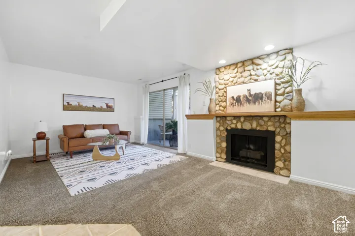 Stone-clad fireplace with wood mantel
