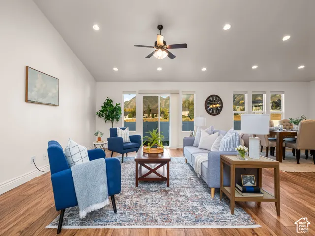 Recessed lighting, wood-finish flooring, ceiling fan, sliding glass door, and multiple windows