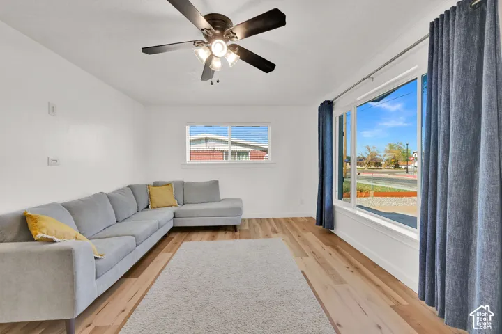 Recessed lighting, wood-finish flooring, and a large picture window