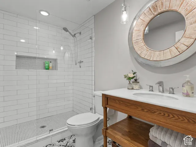 Walk-in shower with subway tile surround and mosaic floor
