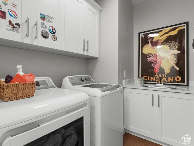 White shaker-style cabinetry, light-toned countertop, stainless steel sink, and wood-finish flooring