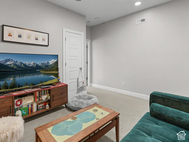 Recessed ceiling lighting, light gray wall finish, white baseboards, and a white paneled door