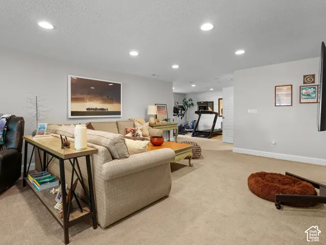 Recessed lighting, light gray wall paint, and beige carpeting