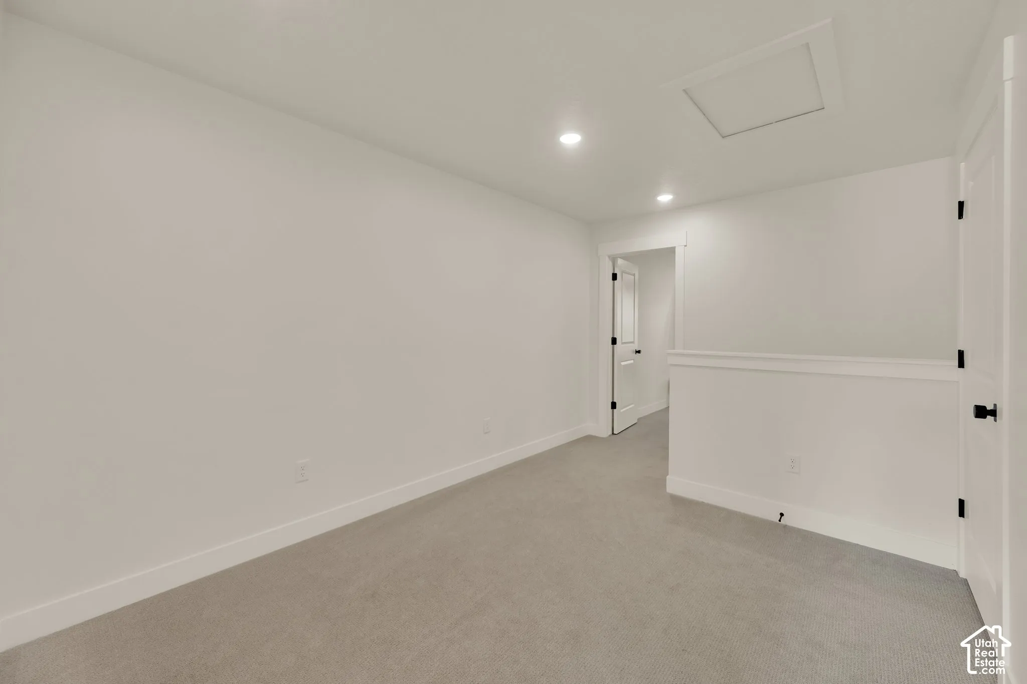 Recessed lighting, light gray carpeting, white walls, and white trim