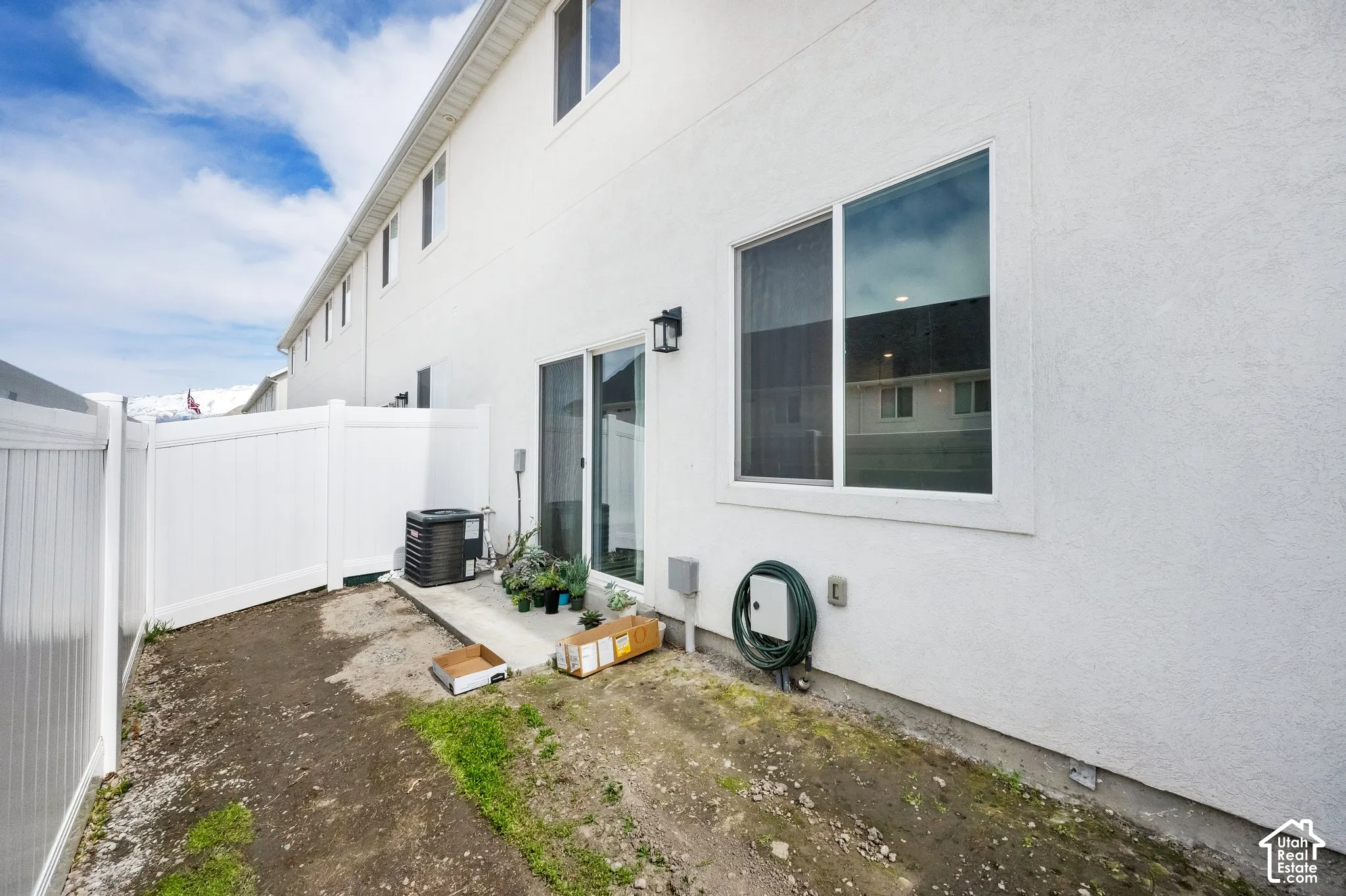 White stucco exterior with multiple windows