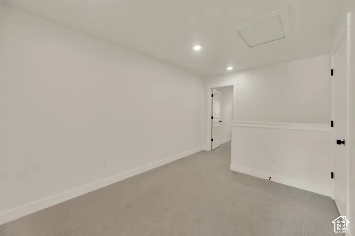 Recessed lighting, light gray carpeting, white walls, and white trim
