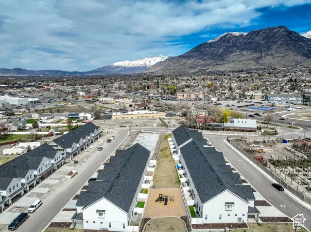 New construction townhomes featuring modern siding, dark shingle roofs, and paved roads