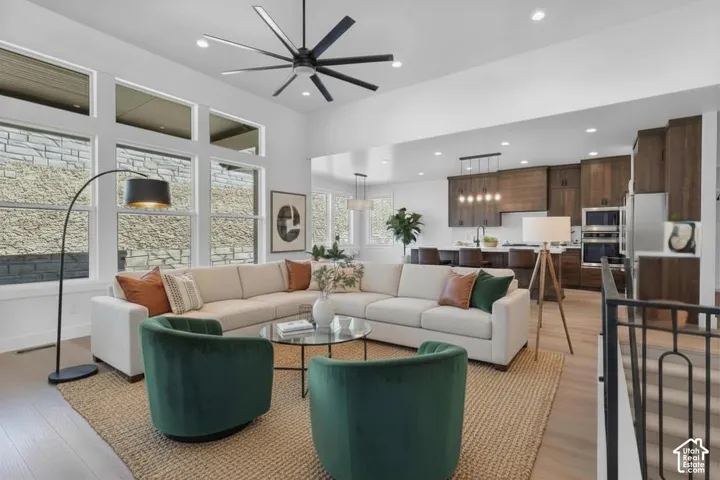 Open-concept living space featuring wood-finish flooring and a contemporary ceiling fan
