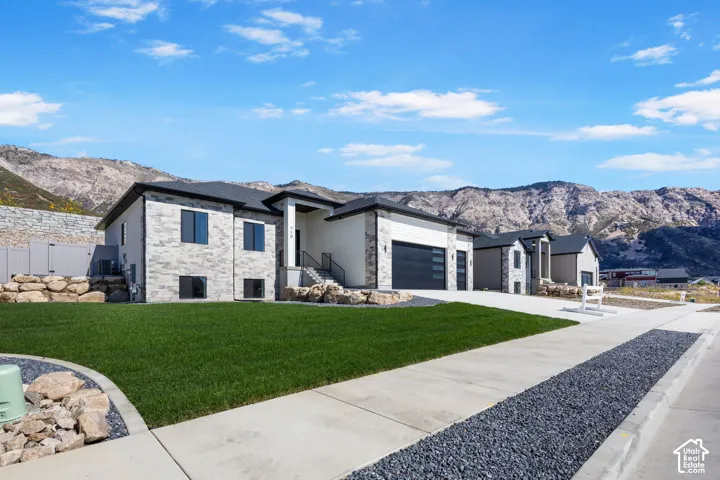 Modern exterior featuring light-colored stone and dark siding accents